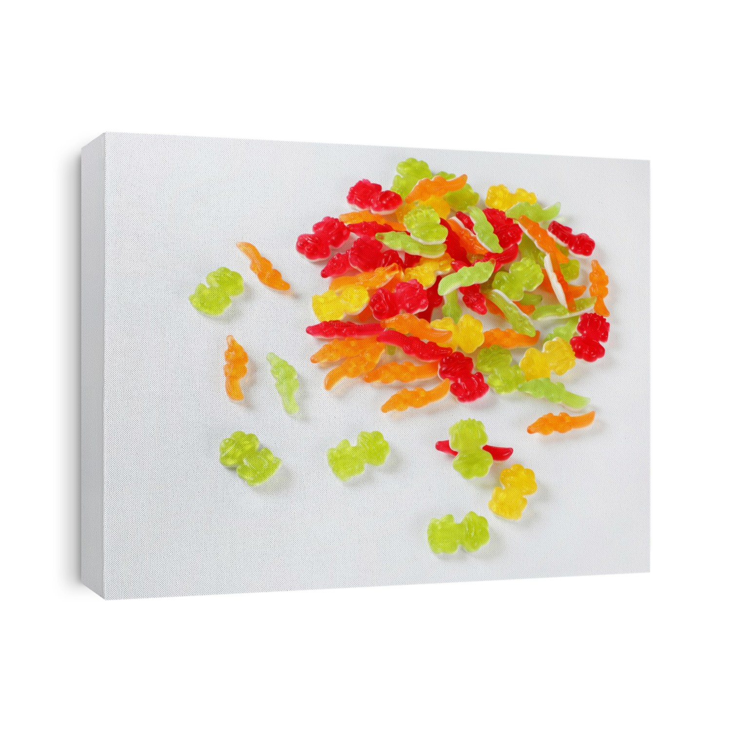 pile of colorful gummy candies in the shape of animals on white background